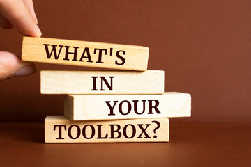 Wooden blocks with words 'What's In Your Toolbox?'.