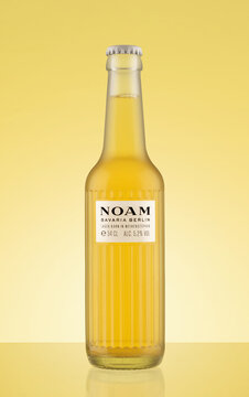 Bottle of Noam Lager Beer on yellow background. Lager born in Weihenstephan