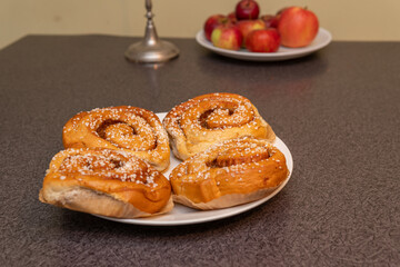 Many tasty cinnabons buns (kanelbullar) with sugar filling, swedish specialty