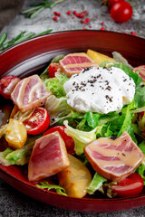 Strachatella. Sea fresh green salad mix with tuna, poached egg, cherry tomatoes and potatoes.