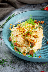 Hazelnut risotto on a gray stone table