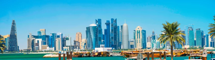 Fotobehang City of Doha panorama with skyscrapers of West Bay downtown district, gulf and Al Corniche road traffic. Doha, Qatar © Pavlo Vakhrushev