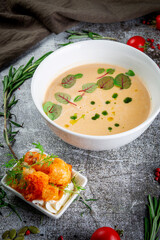 Pumpkin carrot puree soup on a gray stone table