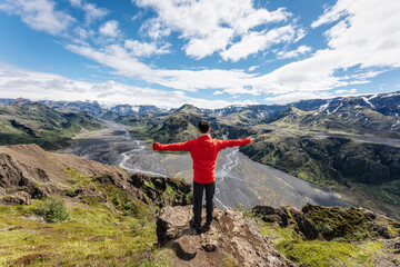 Obraz premium Male hiker standing with cheerful on top of mountain in Valahnukur viewpoint