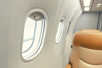 closeup aircraft passenger cabin interior windows seat row. aeroplane round safety glass window.