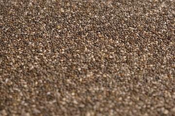 Chia Seeds Wallpaper. Raw Chia Seeds Surface. Close Up, Top View, Macro. Superfood. Full Frame. Food Background. Shiny textured White, Gray and Brown Chia. Paleo Diet Concept.