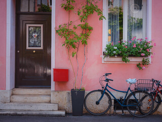 Fototapeta na wymiar Buildings in the city centre of Basel , Switzerland. Colorful house with bike near entrance