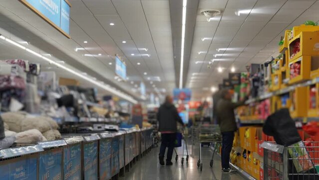 UK discount supermarket shopping aisle.
Wide angle shot down the aisle of a discount supermarket in the UK. Blurred for anonymity.