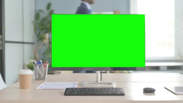 Desktop Computer with Green Screen on Desk
