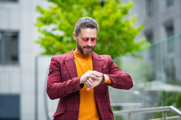 punctual man check time on wrist watch outdoor. man wear stylish watch. punctual man in jacket.