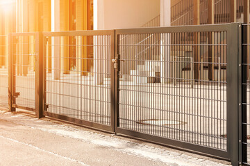 Gate or Door to Private School Territory. Modern Simple Gates with Sun Light
