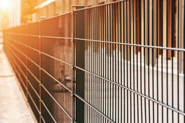 Fence Panel from Metal Grid. Grating Wire industrial Fence. Fence around Private Property Territory on Sun Light.