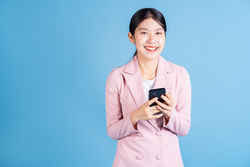 Image of young Asian woman using smartphone on background