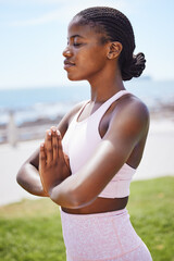 Nature yoga, meditation and black woman praying for spiritual wellness on the grass in the city of...