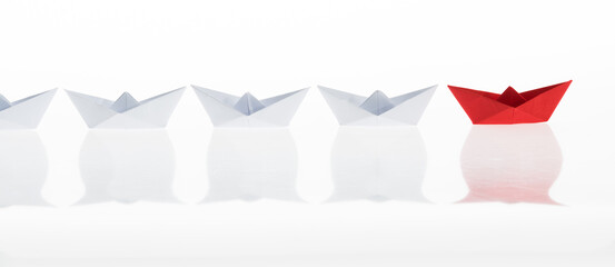 The red origami boat is leader