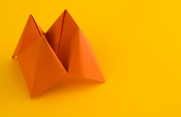 Fototapeta na wymiar Origami paper fortune on yellow background