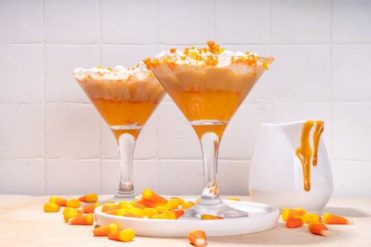 Candy Corn Martini Cocktail Martini Drink. Sweet And Salty Pumpkin Caramel Cocktail, With Candy Corn Candies, Copy Space