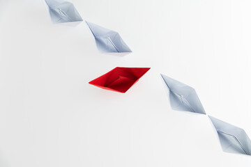 A red origami boat stands out