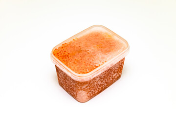 red caviar in a plastic container on a white background