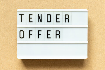 Lightbox with word tender offer on wood background