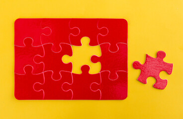 Jigsaw puzzle with missing piece on yellow background