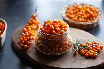 Sea buckthorn berries in a jar, orange healthy berries, macro