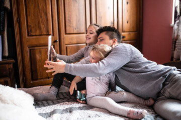 Father playing and joking with his daughters in bedroom
Cozy time wih father
Father daughter time