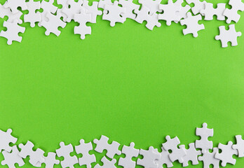 Pieces of jigsaw puzzle on green background