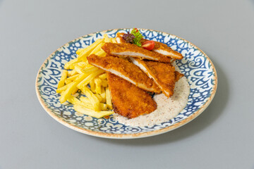 Tender pan fried chicken breasts served with french fries