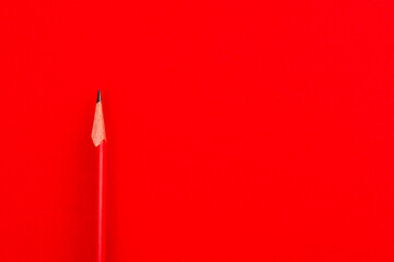 Red pencil on red background