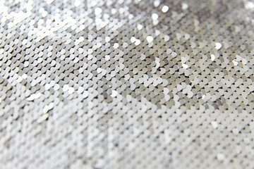 fabric is covered with silver sequins. Abstract background and backdrop. Antistress