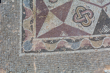 old mosaic in paphos, cyprus with an antique roman ruin