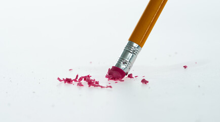 Pencil erasing mistake on white background