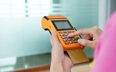 Close up of hand paying with credit card