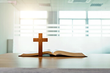 Wooden cross and bible book on the table