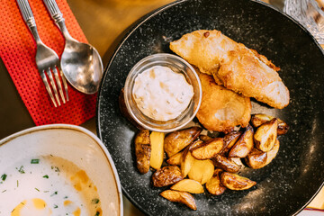 Soup: Cullen skink - thick Scottish soup with smoked white fish and appetizer: Fish Chips, tartar sauce. Traditional cuisine of Scotland. Flat view.