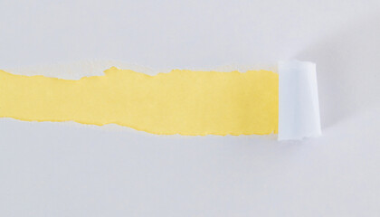 White torn paper on yellow background