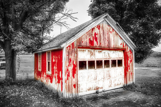 Selective Red Color in a Black and White photo of an old garage in need of repair.  Paint peeling off this building creates lots of texture in this photo taken in Windsor in Upstate NY.