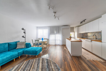 New modern living room with kitchen. New home. Interior photography. Wooden floor.
