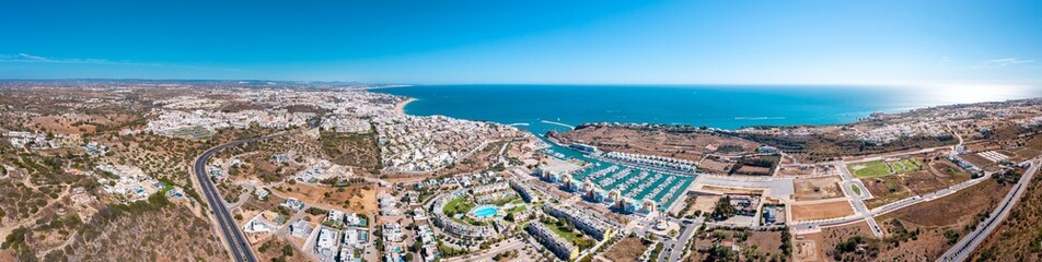 Sensational aerial panorama of Albufeira city. View of port of Albufeira with luxury urbanisation. At left the city of Albufeira. Famous travel destination in Algarve, Portugal. 21 merged images