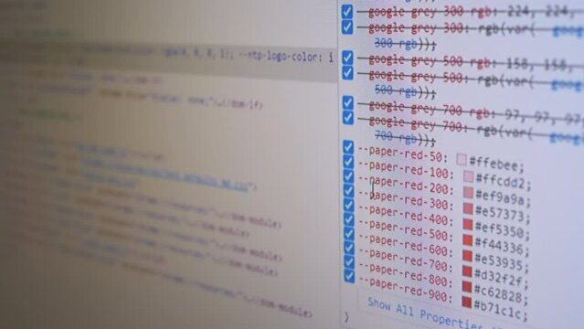 Programmer Views the HTML Code of the Page on a Screen of a Computer Monitor. Code scrolling. Study, analysis of a web page, site. Signs, symbols, numbers, words. Software. White abstract background.