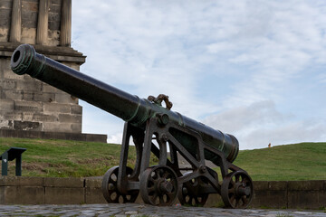 cannon on Calton hill with neoclassical monuments