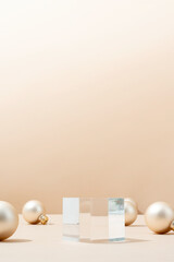 A minimalistic scene of glass podium with christmas pine tree and balls on beige background