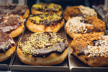 Rich variety of sugar glazed donuts in a showcase.