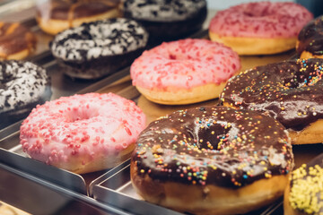 Rich variety of sugar glazed donuts in a showcase.