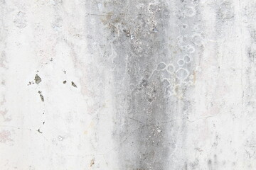 A weathered concrete wall with cracks and peeling paint, showing signs of age and decay.