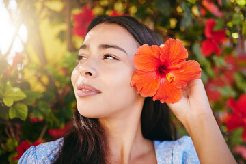 Woman, flower and garden on vacation in Hawaii, having fun in summer and nature. Mexican female in a zen park, relax and content while picking pretty flowers and enjoying freedom, fresh air and sun