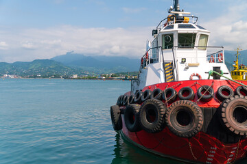 Ship Tamara in the port of Batumi against the background of mountains on a sunny day
