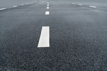 Fototapeta premium Asphalt road with white dashed lines