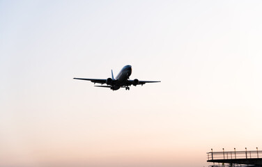 Background of airplane landing at sunset